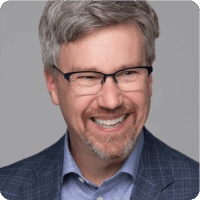 Erik Rucker Big Smile Glasses Head Shot